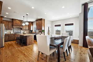 Dining room with light wood-style floors, recessed lighting, a textured ceiling, and baseboards