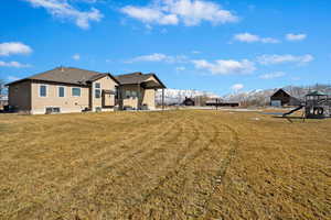 View of yard with central AC, a playground, and a mountain view