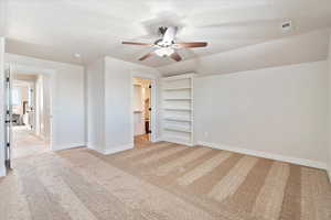 Unfurnished bedroom with light carpet, baseboards, visible vents, lofted ceiling, and a textured ceiling