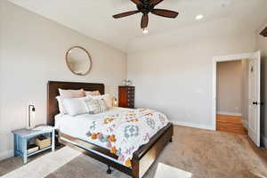 Bedroom with recessed lighting, light carpet, a ceiling fan, baseboards, and vaulted ceiling