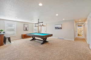 Recreation room with recessed lighting, visible vents, baseboards, and light colored carpet