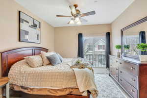 Bedroom featuring access to outside and a ceiling fan