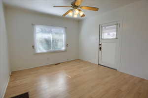 Entrance foyer featuring ceiling fan, and light wood-style floors