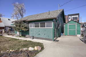 Bungalow-style home with a fence, and a shed