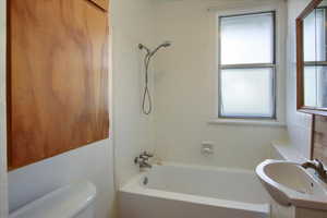 Full bath with toilet, vanity, and shower / bathing tub combination