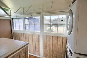 Laundry area featuring laundry area and stacked washer and clothes dryer