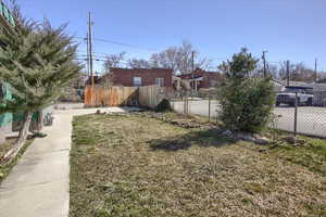 View of yard featuring a residential view and fence