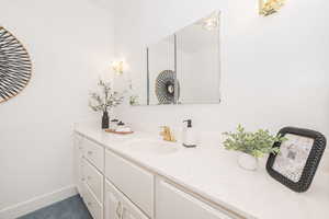 Bathroom with vanity and baseboards