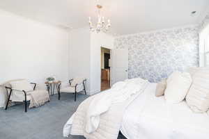 Bedroom with visible vents, wallpapered walls, crown molding, carpet floors, and an inviting chandelier