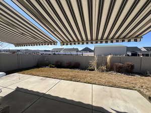 View of patio with a fenced backyard