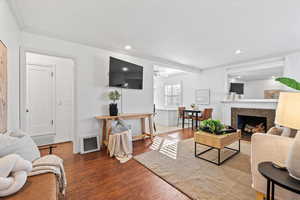 Beautiful Living Room with Gas Fireplace, Crown Molding, Can-Lighting, & Hardwood Floors