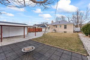 Exterior of home with new concrete, fencing, & a beautiful yard