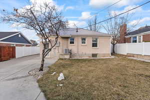 Exterior of home with new concrete, fencing, & a beautiful yard