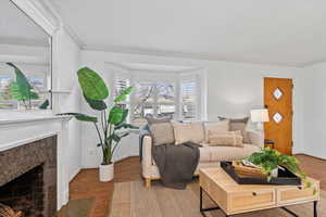 Beautiful Living Room with Gas Fireplace, Crown Molding, Can-Lighting, & Hardwood Floors