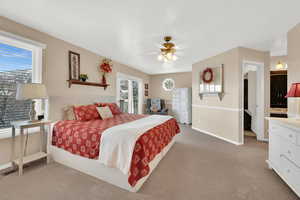 Bedroom with ceiling fan, carpet flooring, and baseboards