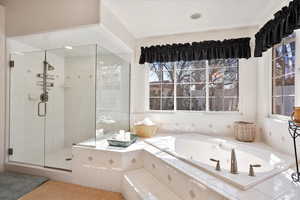 Bathroom featuring a shower stall and a whirlpool tub