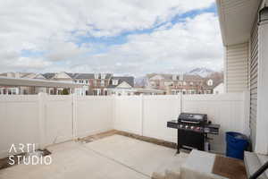 View of patio / terrace with a residential view, a fenced backyard, and a mountain view