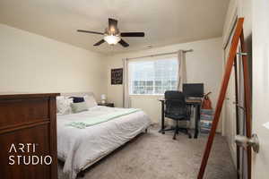 Carpeted bedroom with a ceiling fan