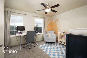 Carpeted room with ceiling fan