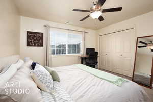 Bedroom with ceiling fan, carpet, and a closet