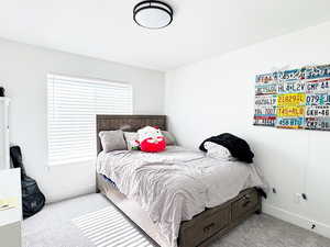 Carpeted bedroom with baseboards