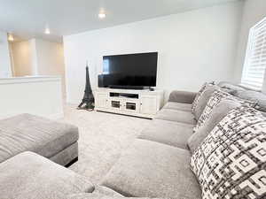 Carpeted living room featuring baseboards and recessed lighting