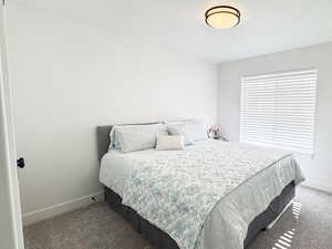 Carpeted bedroom featuring baseboards