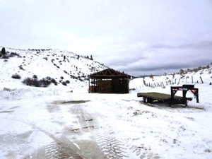 Snowy yard featuring a gazebo and a mountain view