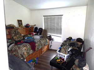Bedroom featuring dark wood-type flooring