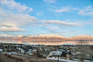 Property view of mountains with a water view and a residential view