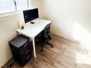 Office area featuring light wood-style floors