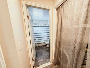 Bathroom with a textured ceiling and toilet