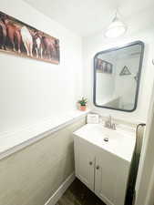 Bathroom featuring wood finished floors, a textured ceiling, and vanity