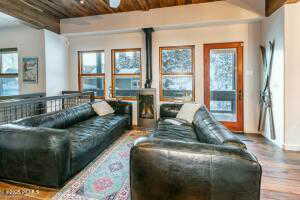 Living room featuring a healthy amount of sunlight, wood ceiling, wood-type flooring, and ceiling fan