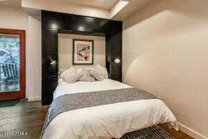 Bedroom with dark wood-type flooring