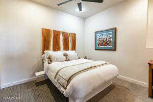 Bedroom with ceiling fan and carpet