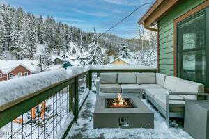 Snow covered back of property with an outdoor hangout area