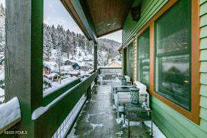 View of snow covered back of property