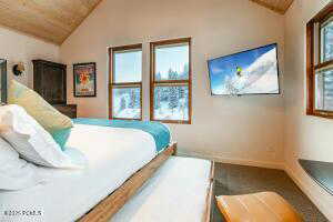 Carpeted bedroom with lofted ceiling and wooden ceiling