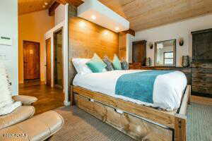 Bedroom featuring wooden ceiling and beam ceiling