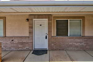 Property entrance featuring brick siding