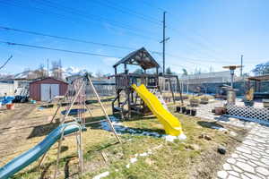 View of play area featuring a shed and an outdoor structure