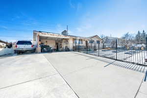 GARAGE Door coming soon :)View of front of home with an attached carport, fence, and driveway