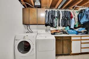 Clothes washing area with washing machine and clothes dryer and cabinet space