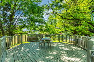 Wooden terrace featuring outdoor dining area