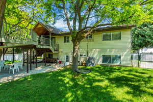 Back of property featuring a yard, a patio area, and fence