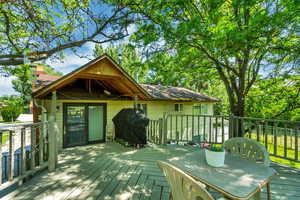 Deck featuring outdoor dining space and a grill