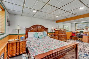 Bedroom featuring recessed lighting and wood walls