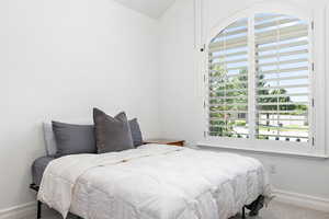 Carpeted bedroom featuring baseboards