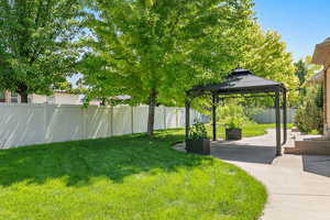 View of yard with a patio area, a fenced backyard, and a gazebo